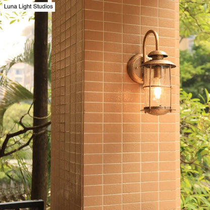 Coastal Clear Glass Wall Sconce with Brass Cage and Cylinder Light