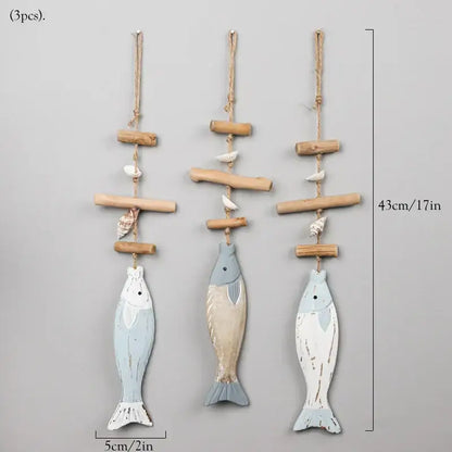 Three rustic wooden fish wall hangings with faded blue and white distressed finishes and seashells for decorbites coastal wooden decor