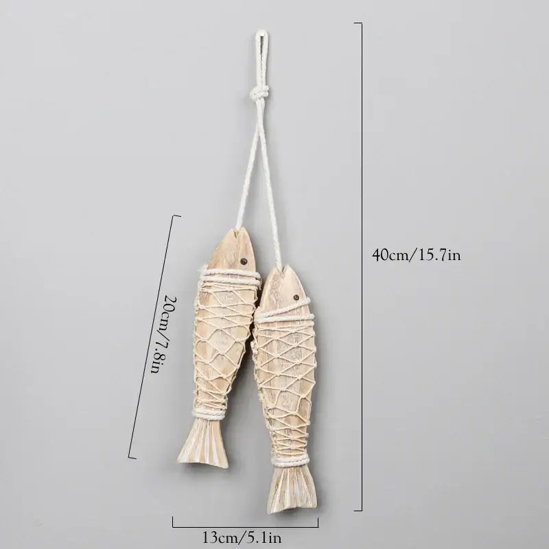 Two beige handcrafted wooden fish ornaments with woven rope detailing for decorbites coastal wooden ship model decor