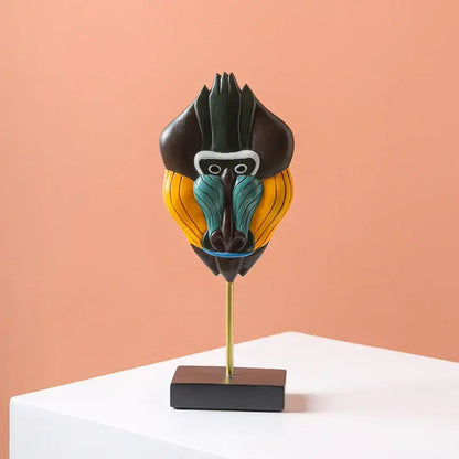 Vibrant hand-painted african abstract face monkey sculpture with black yellow teal accents on gold stand for living room decorbites african abstract decor