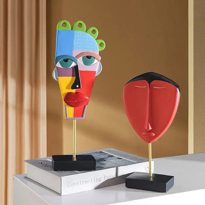 Vibrant decorbites african abstract face sculpture in bold blue red yellow and green geometric sections on gold stand