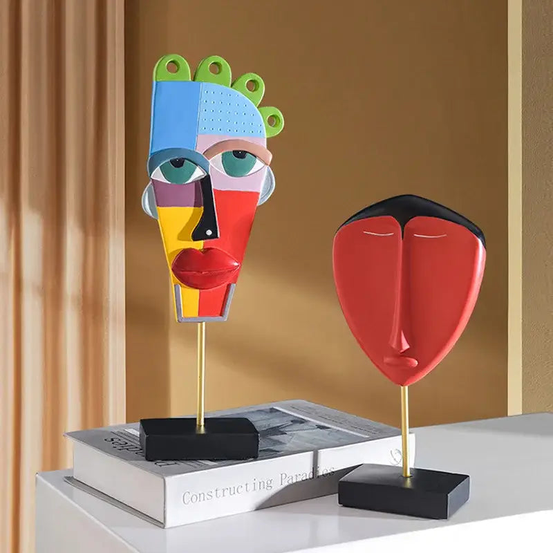 Vibrant decorbites african abstract face sculpture in bold blue red yellow and green geometric sections on gold stand