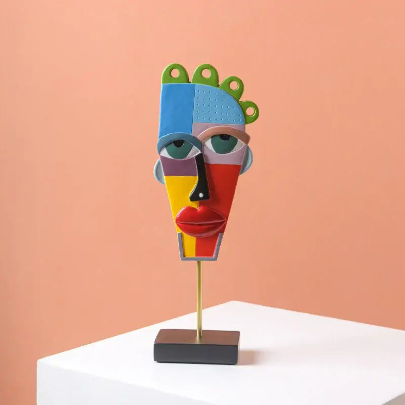 Colorful african abstract face monkey sculpture with vibrant geometric sections on gold stand for living room decorbites african abstract decor