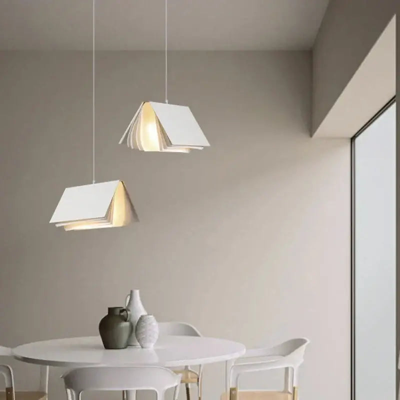 White minimalist book pendant lamp with layered paper design suspended by thin cords for living room decorbites decor
