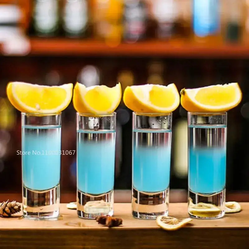 Colorful decorbites bullet cocktail glass set of 6 with clear glass shot glasses filled with blue liquid and lemon wedges