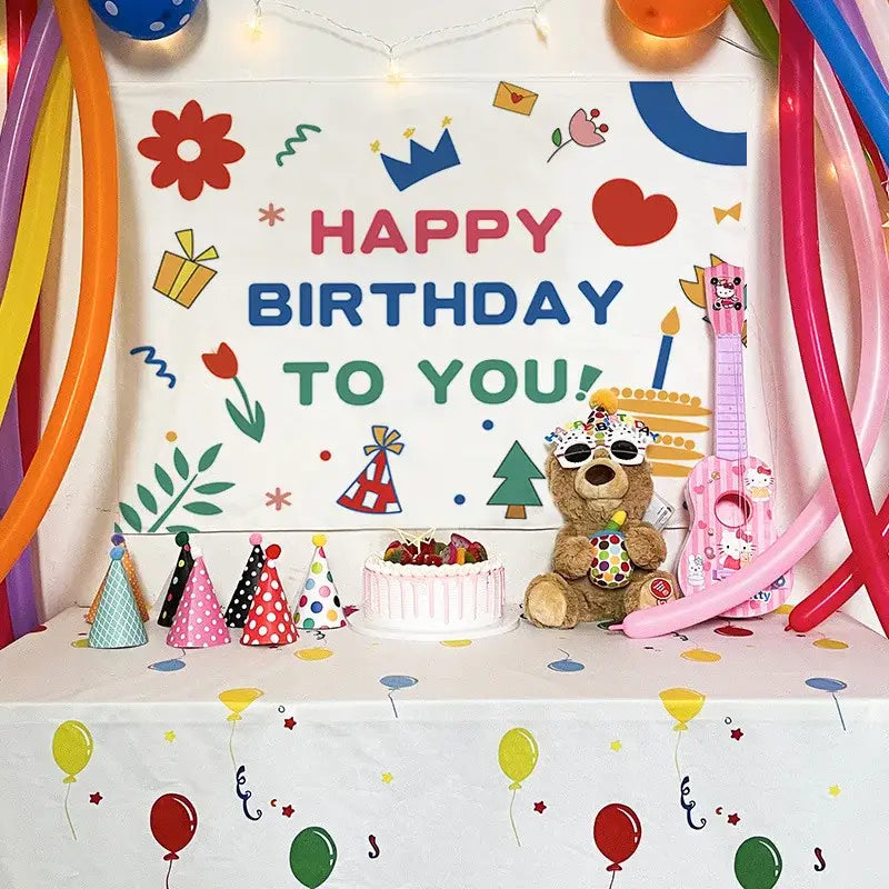 A colorful cartoon animal birthday wall tapestry featuring a brown teddy bear with sunglasses and party decorbites birthday wall