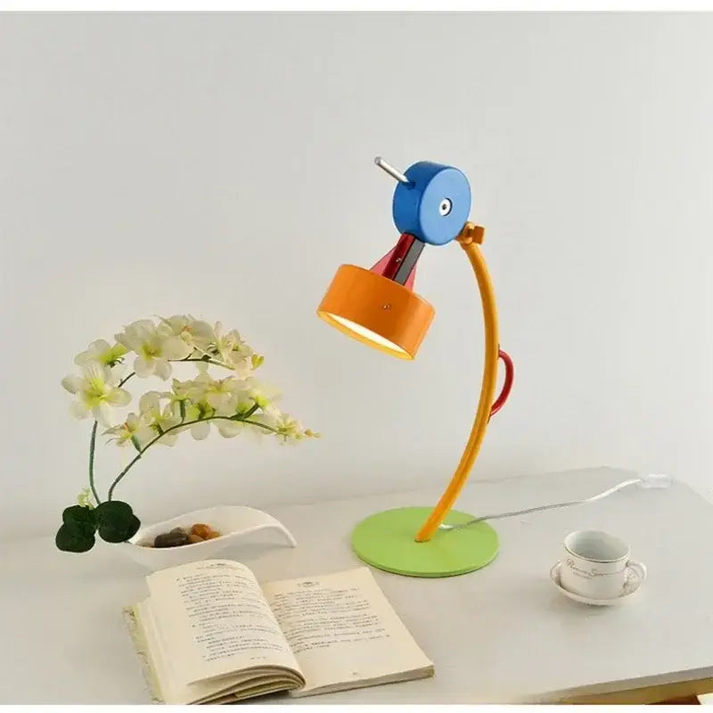 A colorful cartoon led floor lamp with blue circular head orange shade and green base for living room accent lighting