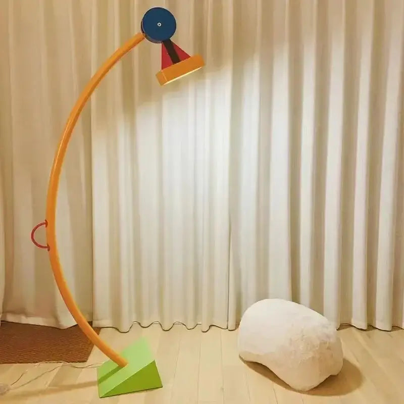 A vibrant curved led floor lamp with playful orange blue red and yellow geometric design for living room lighting