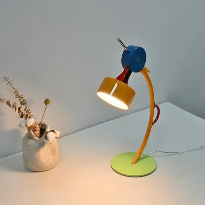 Colorful cartoon led floor lamp with a curved yellow arm blue head and lime green base for living room accent lighting