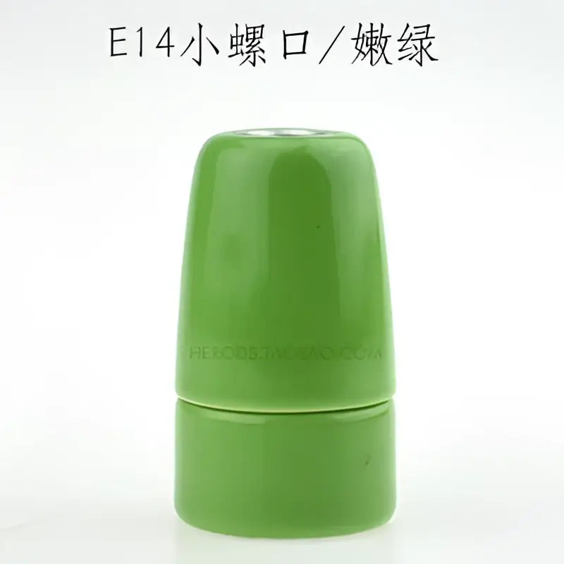 A sleek glossy jade green decorbites ceramic e14 socket bulb holder with smooth cylindrical design for bedroom and living room
