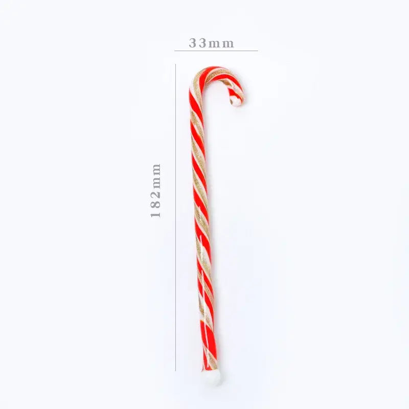 A colorful christmas long handle glass stirring stick candy cane with red white stripes and gold glitter accents