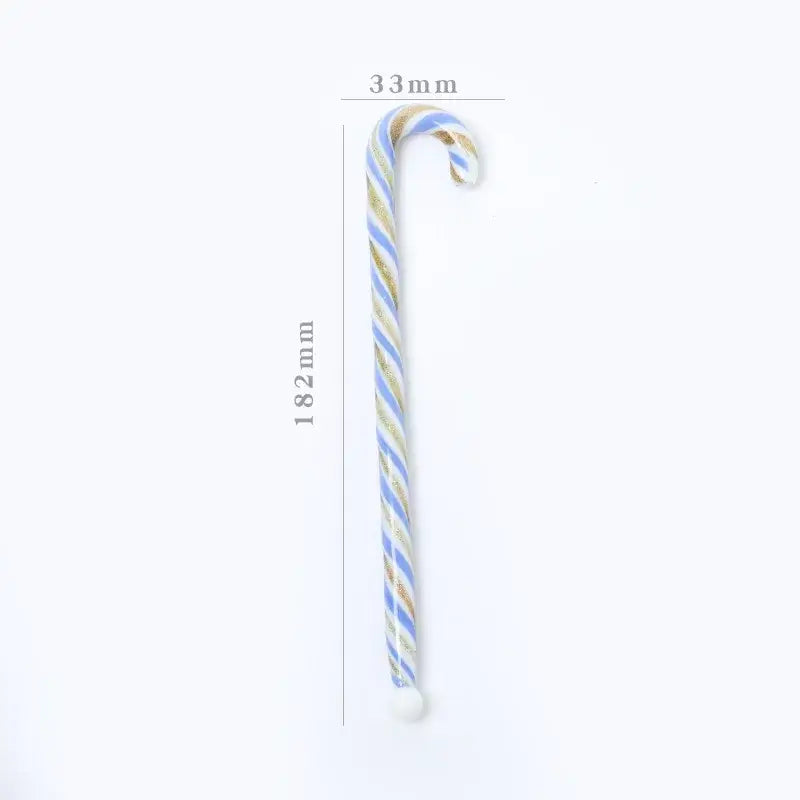 A colorful christmas long handle glass stirring stick shaped like a candy cane with light blue and gold stripes