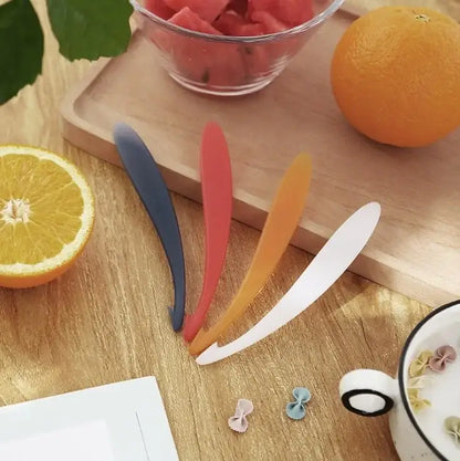 Set of four colorful silicone fruit spoons in blue red orange and white ideal for decorbites citrus zester peeler use