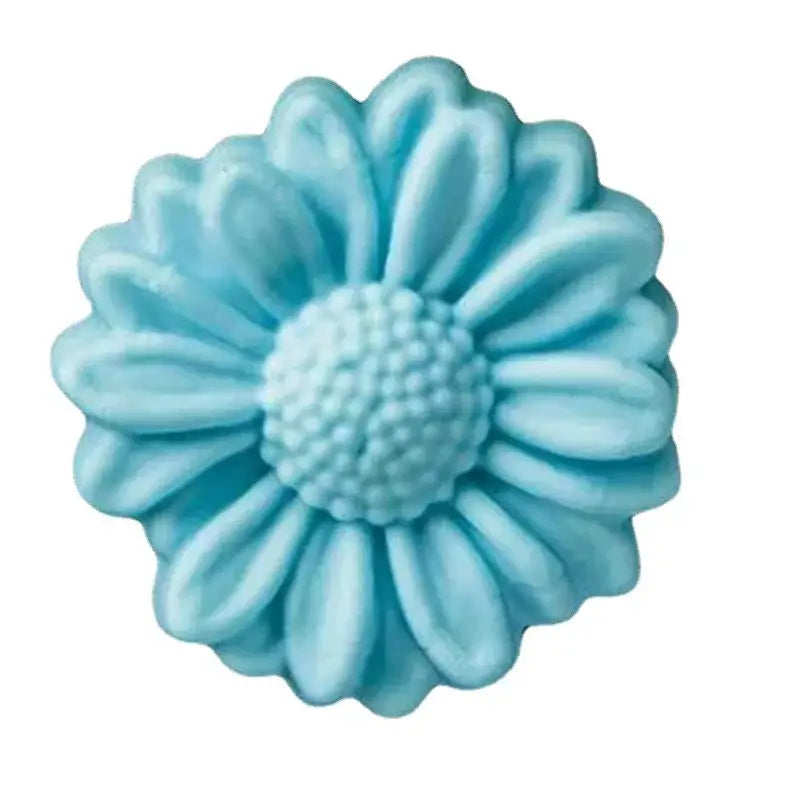 A light blue daisy silicone cake mold with detailed petals and textured center for baking use