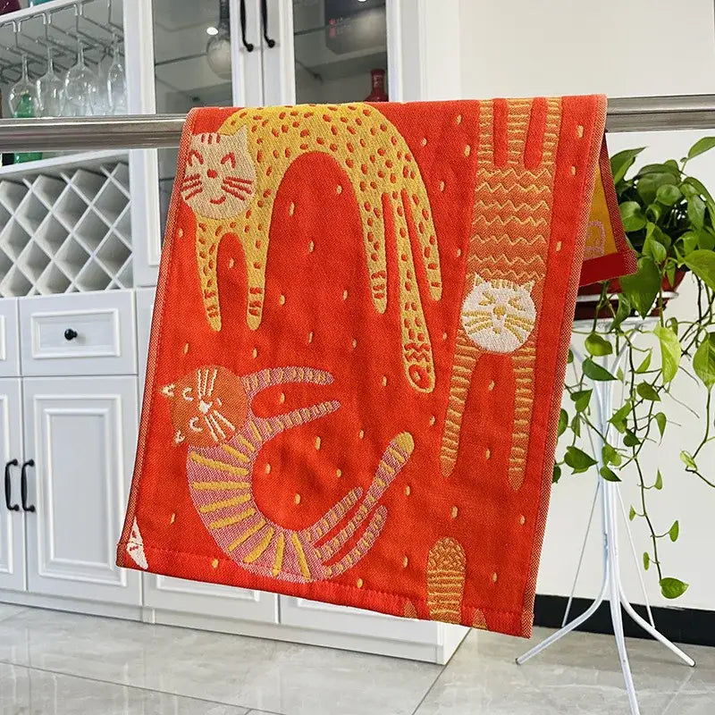 Vibrant orange hand towel from decorbites cat gauze set featuring embroidered yellow and white playful cat designs