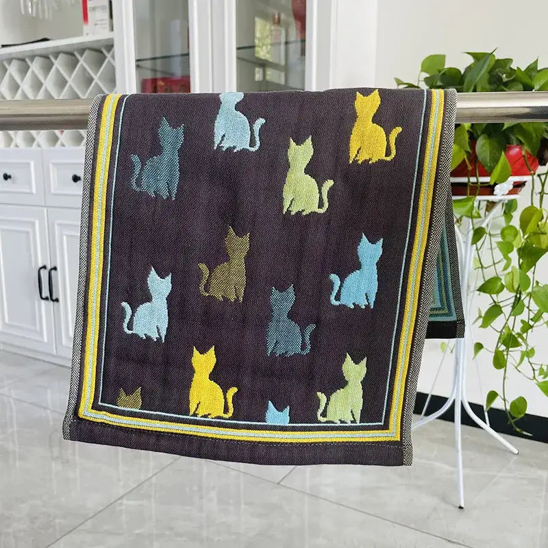 Dark brown hand towel with colorful cat gauze silhouettes in yellow teal light blue and a bold yellow border decorbites cat gauze