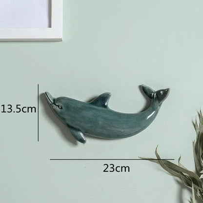 A sleek teal glazed ceramic dolphin fish ocean wall decoration with matte finish for children’s room decorbites wall decoration