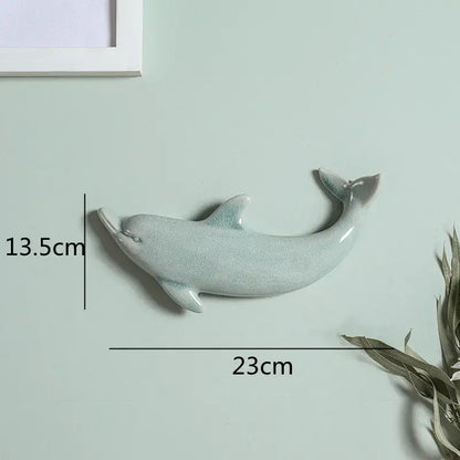 A sleek light blue ceramic dolphin fish ocean wall decoration with glossy crackle glaze for children’s room decorbites wall decoration