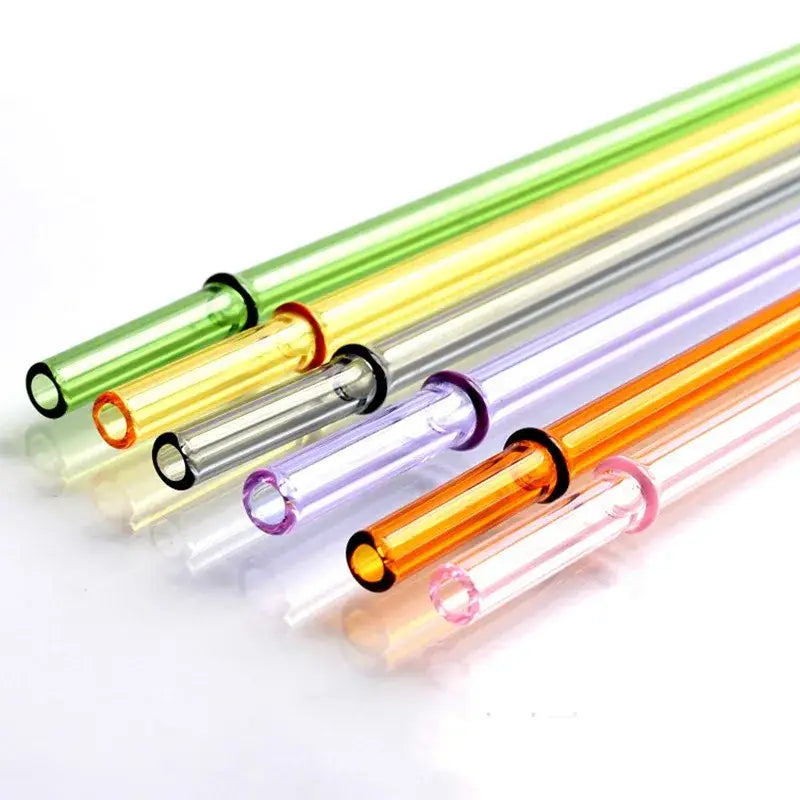 A set of colorful decorbites glass bent straws in green yellow clear purple and orange with rubberized rings for reuse