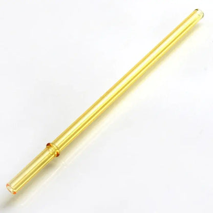 A translucent golden-yellow decorbites glass bent straw with amber accents in a colorful glass bent straw set
