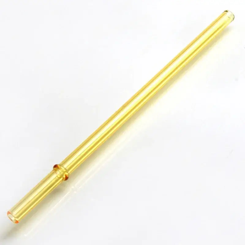 A translucent golden-yellow decorbites glass bent straw with amber accents in a colorful glass bent straw set