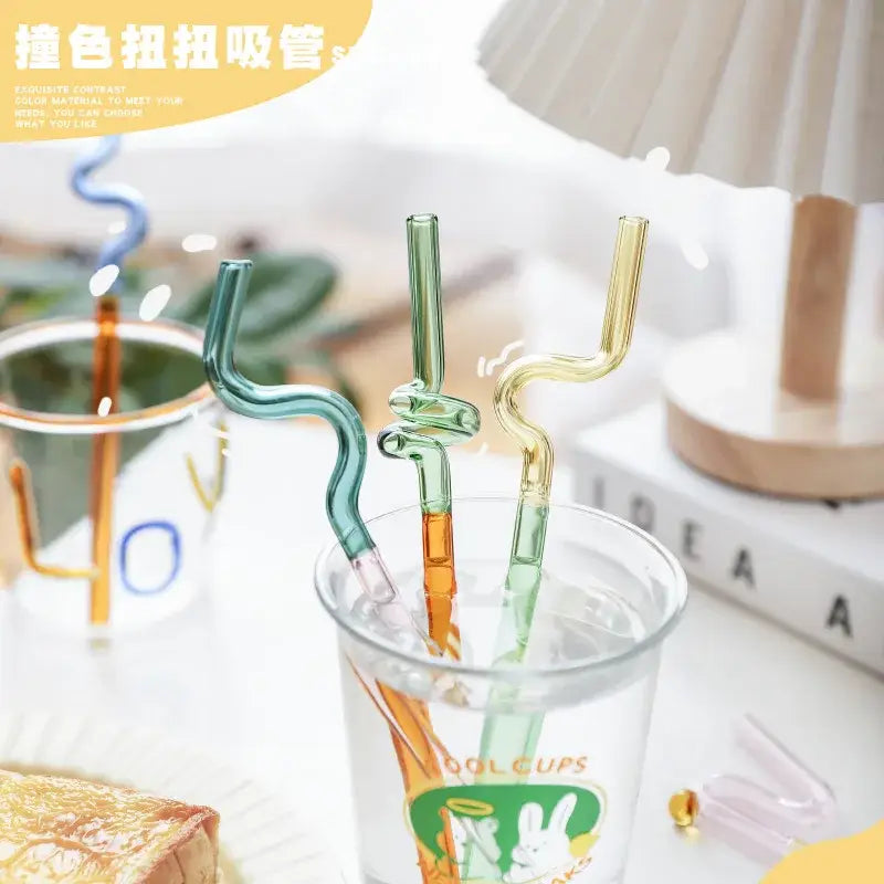 Colorful glass flower handle stir bar cocktail straws in teal green orange and yellow with wavy twisted designs