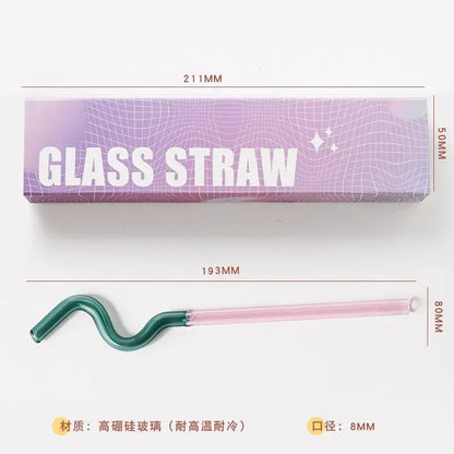 A sleek curved glass flower handle stir bar with a gradient pink and green design for kitchen cocktails