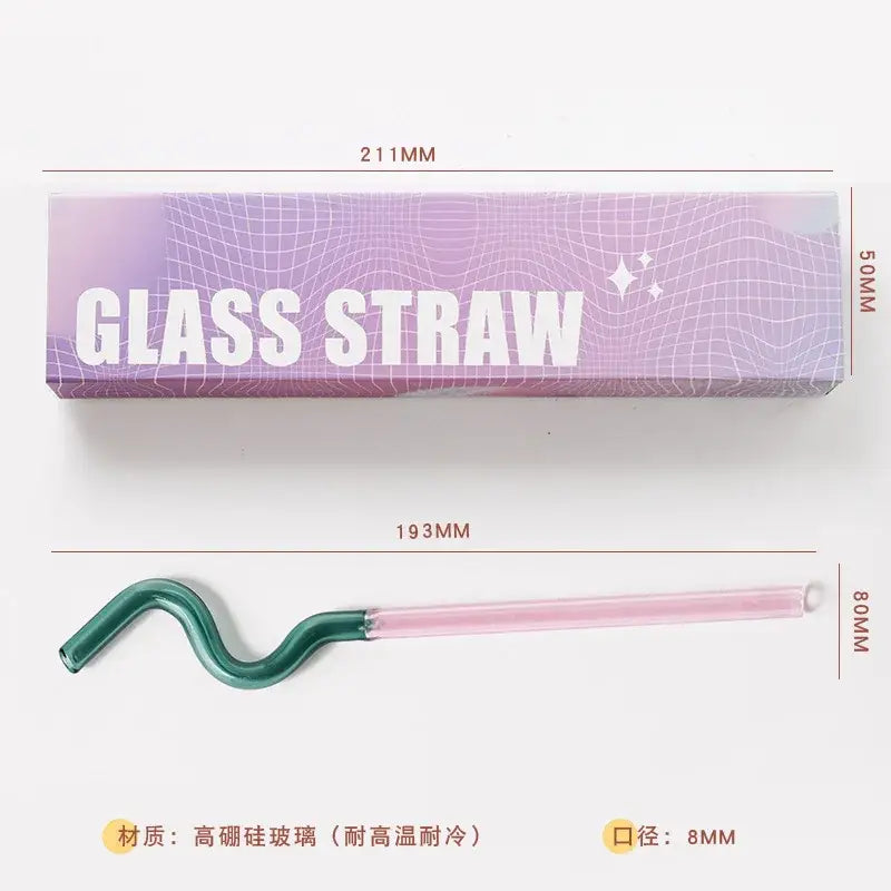 A sleek curved glass flower handle stir bar with a gradient pink and green design for kitchen cocktails