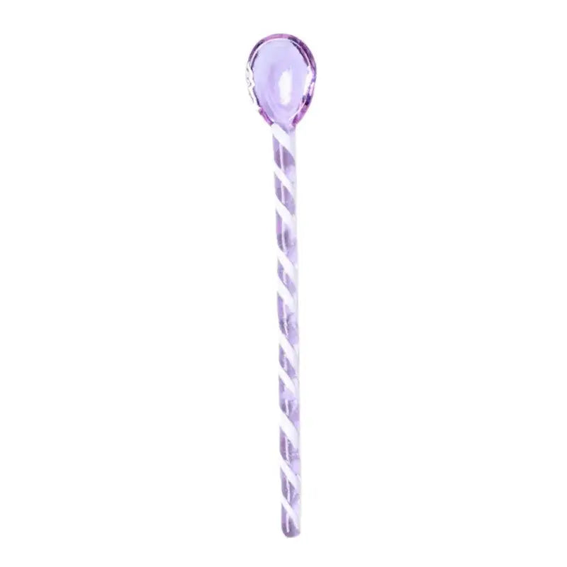 A translucent lavender glass hairpin with a twisted spiral design from decorbites colorful glass stirring spoon set