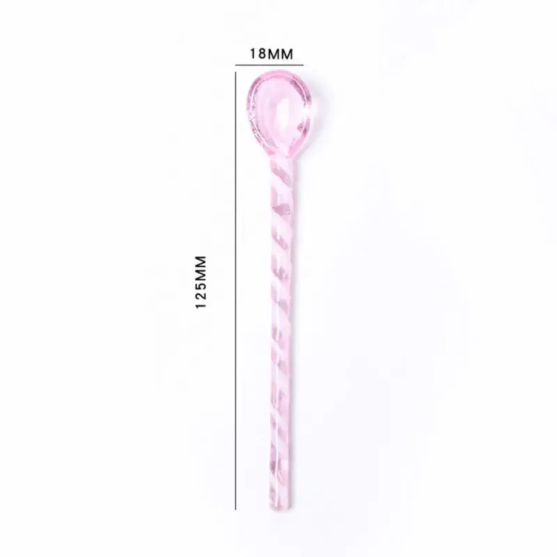A translucent pink colorful glass stirring spoon with a twisted handle and oval bowl for kitchen use by decorbites colorful glass