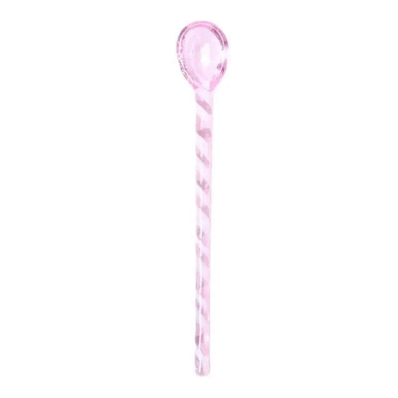 A translucent pink candy cane striped colorful glass stirring spoon from decorbites colorful glass set for kitchen use