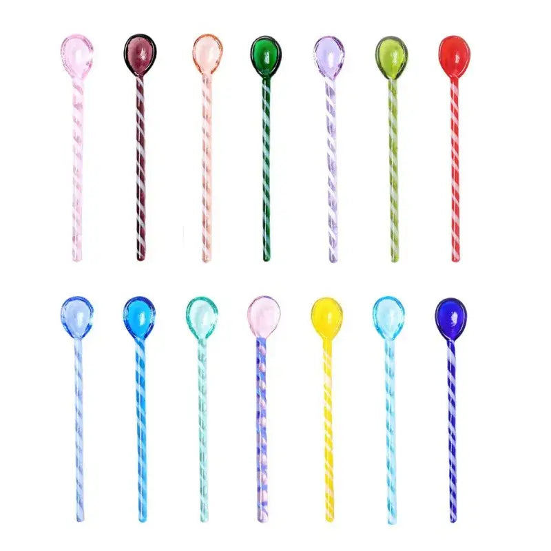 A set of colorful glass stirring spoons with translucent spiral patterns and rounded heads for kitchen and dining use