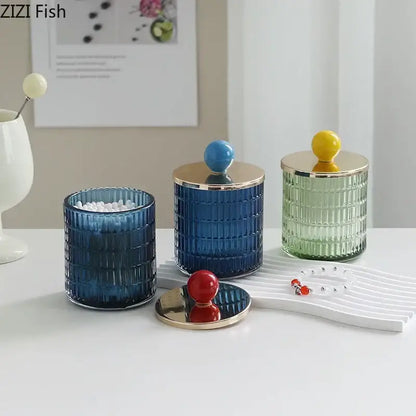 Set of three colorful glass tea canisters with gold ceramic lids in blue green and red storage jars by decorbites