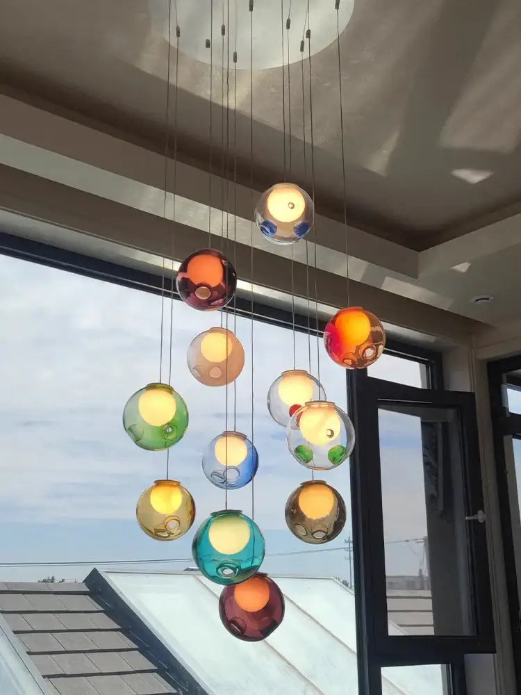 A modern pendant light with colorful glaze glass spheres cascading by thin cords for nursery decorbites colorful glaze decor