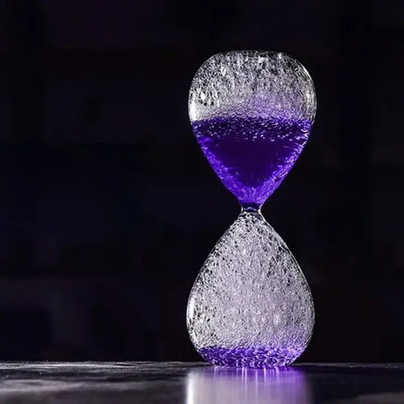 A translucent glass decorbites bubble dream hourglass with crackled texture and vibrant purple liquid for kids bedroom decor