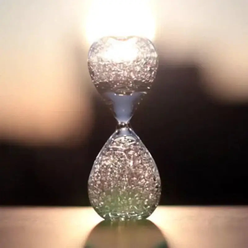 A clear glass decorbites bubble dream hourglass with crackled texture and swirling greenish liquid for kids bedroom decor