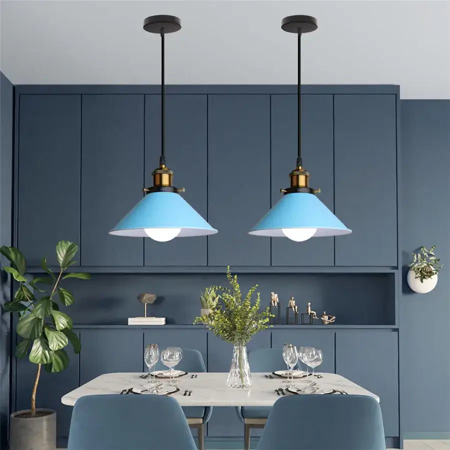 Two matching pendant lights with matte blue conical shades and black cords for decorbites colorful industrial loft decor