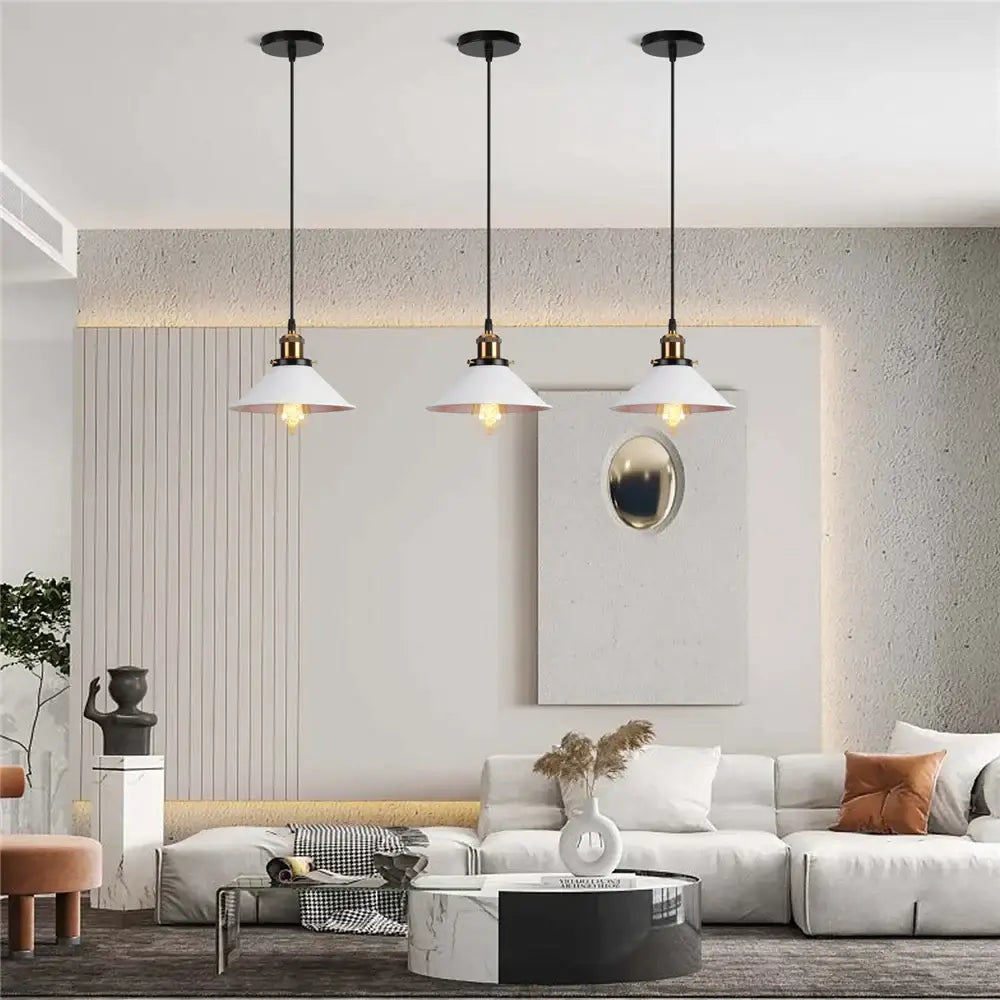 Three white pendant lights with black cords and brass accents in colorful industrial loft pendant light decorbites style