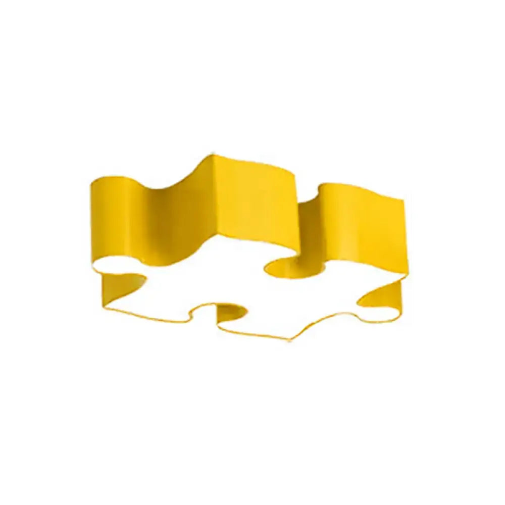 A sleek golden-yellow puzzle piece cookie cutter with a smooth metallic finish for red yellow jigsaw puzzles ceiling flush light