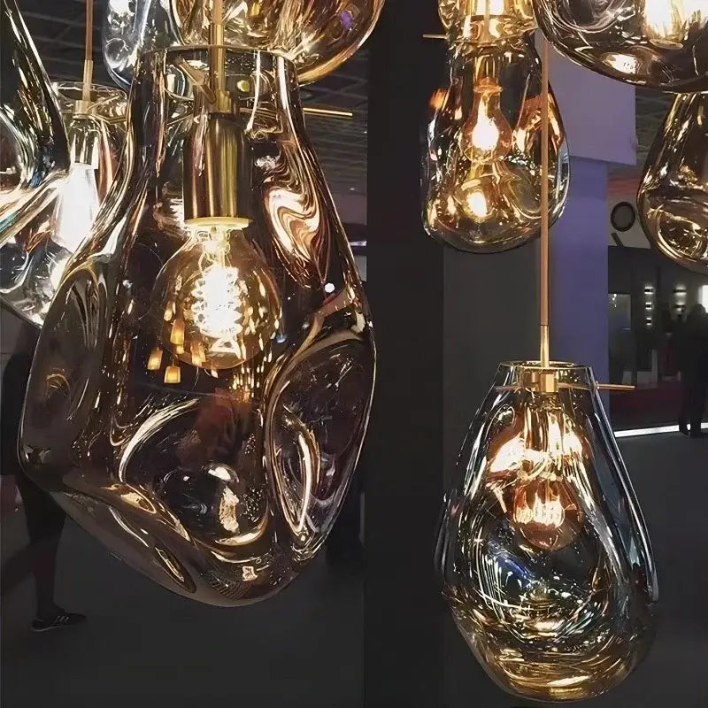 Golden fluidly shaped glass pendant lights with brass accents and exposed filament bulbs for decorbites colorful modern chandelier