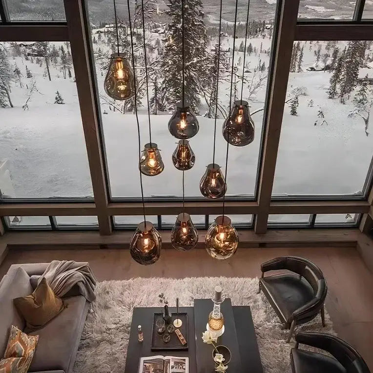 A colorful modern glass chandelier featuring seven amber glass pendant lights with copper accents for dining room decorbites colorful modern