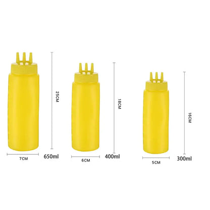 Three yellow plastic decorbites condiment squeeze bottles with three-pronged caps in 300ml, 400ml, and 650ml sizes