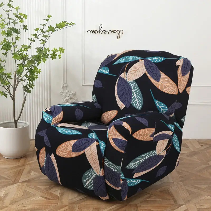 Black armchair with colorful patchwork elastic sofa cover featuring teal tan and navy blue leaf pattern protector