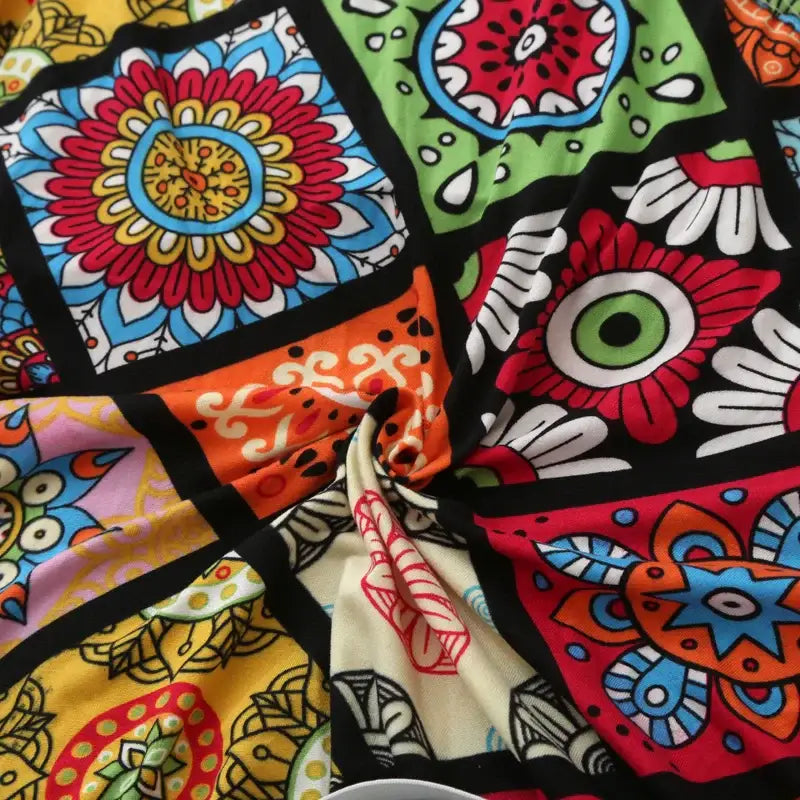 Colorful patchwork elastic recliner sofa cover with bold floral and geometric patterns on black background for living room protection