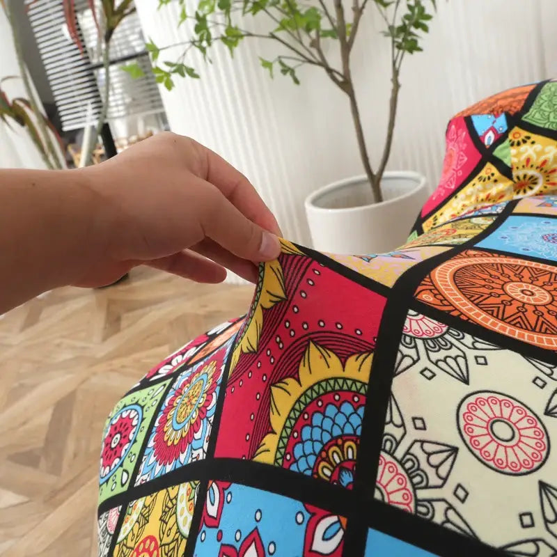 Colorful patchwork elastic sofa cover with vibrant mandala patterns in red yellow blue and green for living room protection