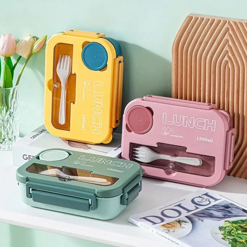 Colorful plastic lunch box set with yellow pink and teal compartments and clear window for utensils storage