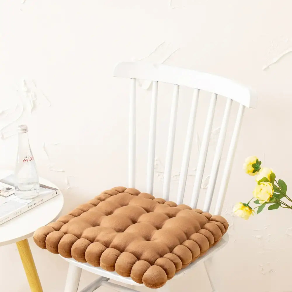 Brown quilted cookie biscuit cushion with soft plush texture and rounded edges for living room decor
