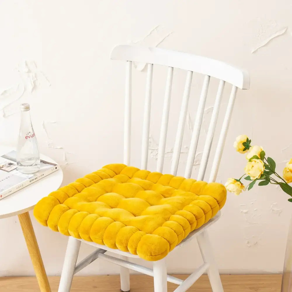 Bright yellow plush quilted cookie biscuit cushion designed for comfort and style in living room use