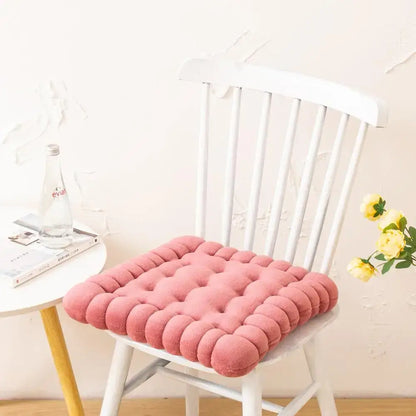 Pink tufted cookie biscuit cushion with soft plush texture and rounded button detailing for living room use