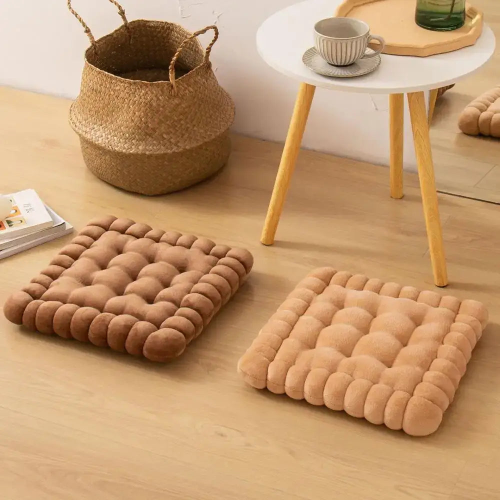 Two beige quilted cookie biscuit cushions with plush bubble texture on wooden floor for living room use